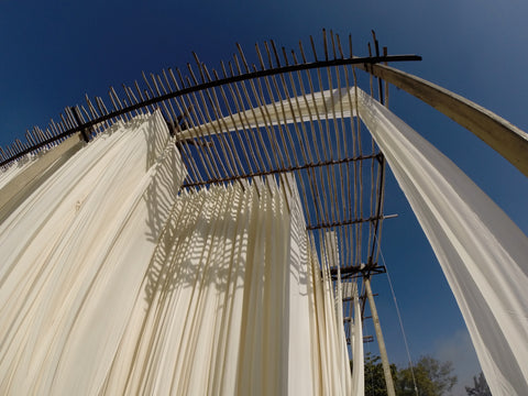 White Indian cotton drying in the desert on large wooden stands