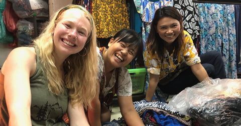 three smiling ladies doing business together in Thailand