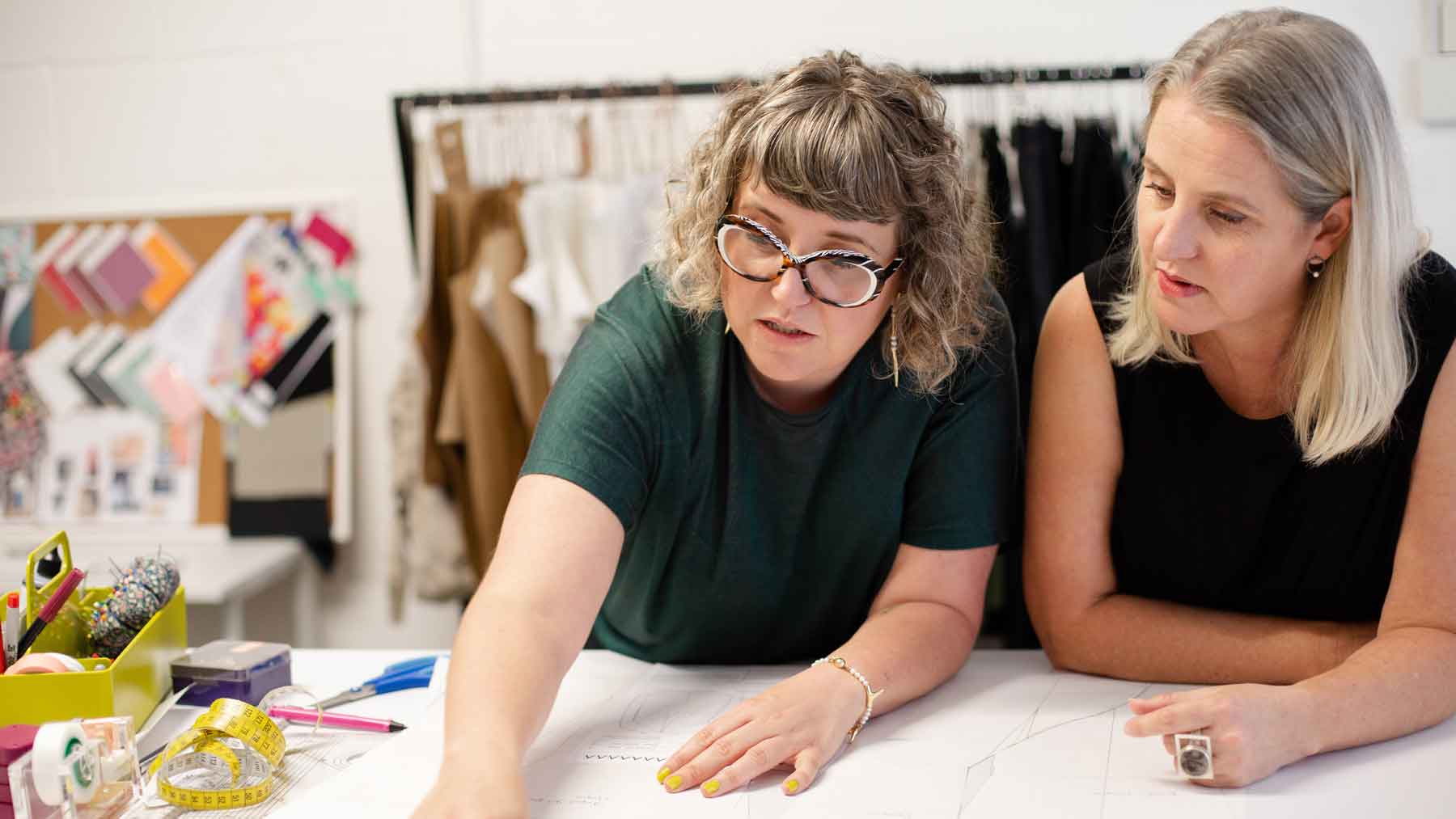 Asmuss Founder Clare and Fiona discussing a pattern in their studio