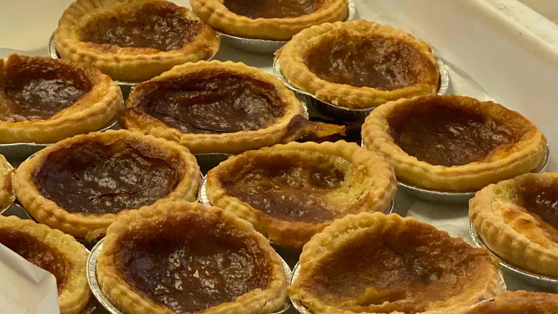 Golden Bakewell Tarts cooling in Bakewell, Peak District