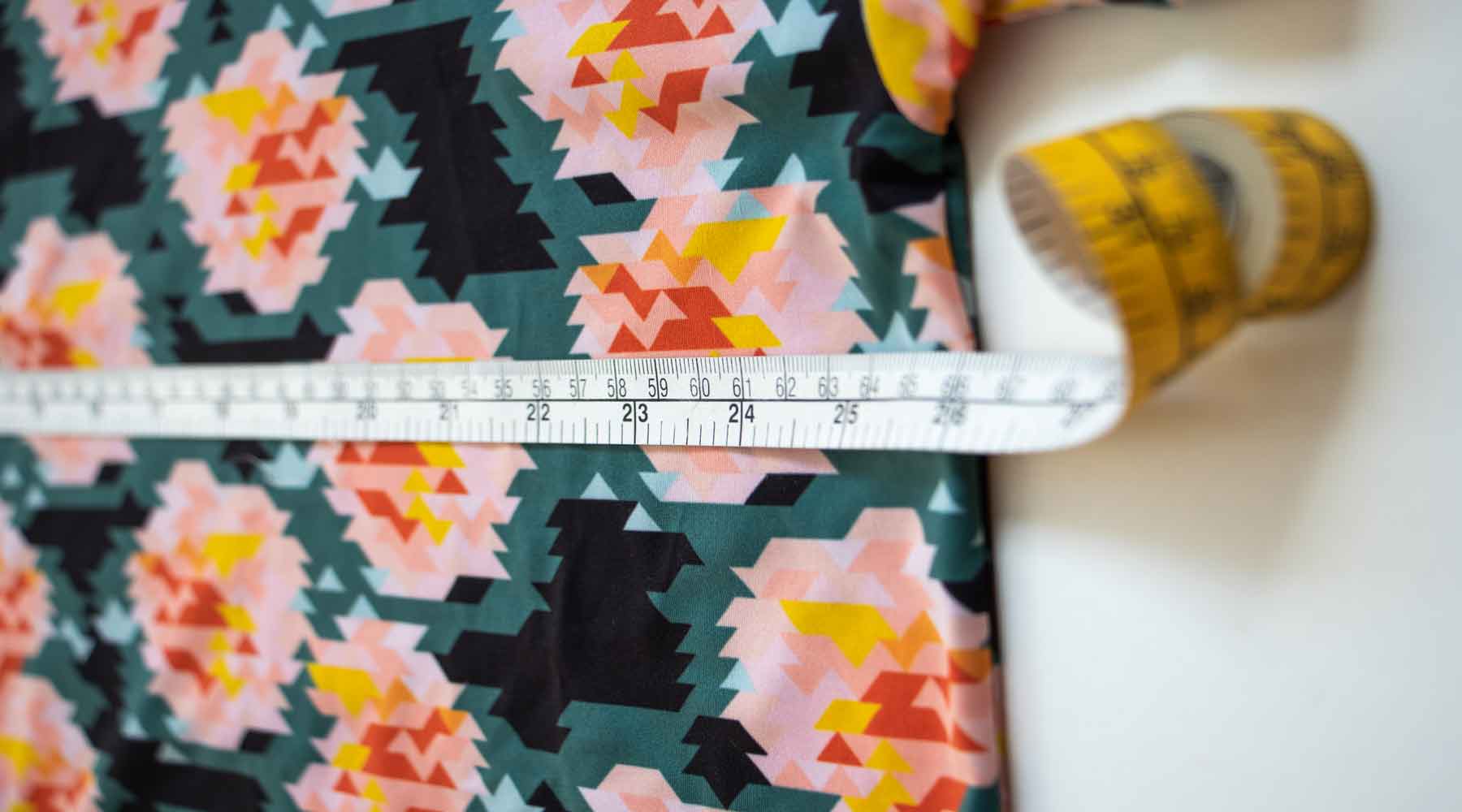 Measuring tape showing where to measure the chest of a t-shirt