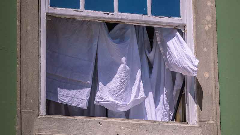 Drying laundry in the sun in the window of a house in Portugal
