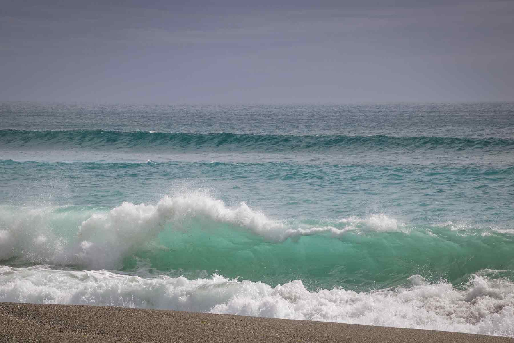 Wave breaking with clear sea green water