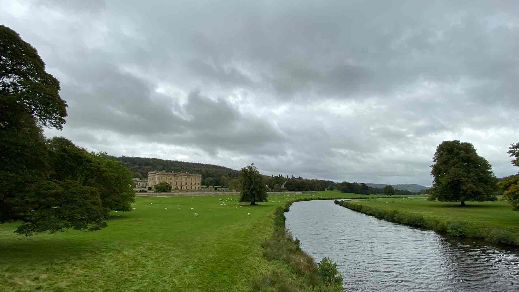 Chatsworth in the distance along the river as part of our exploration of Baslow, Peak District
