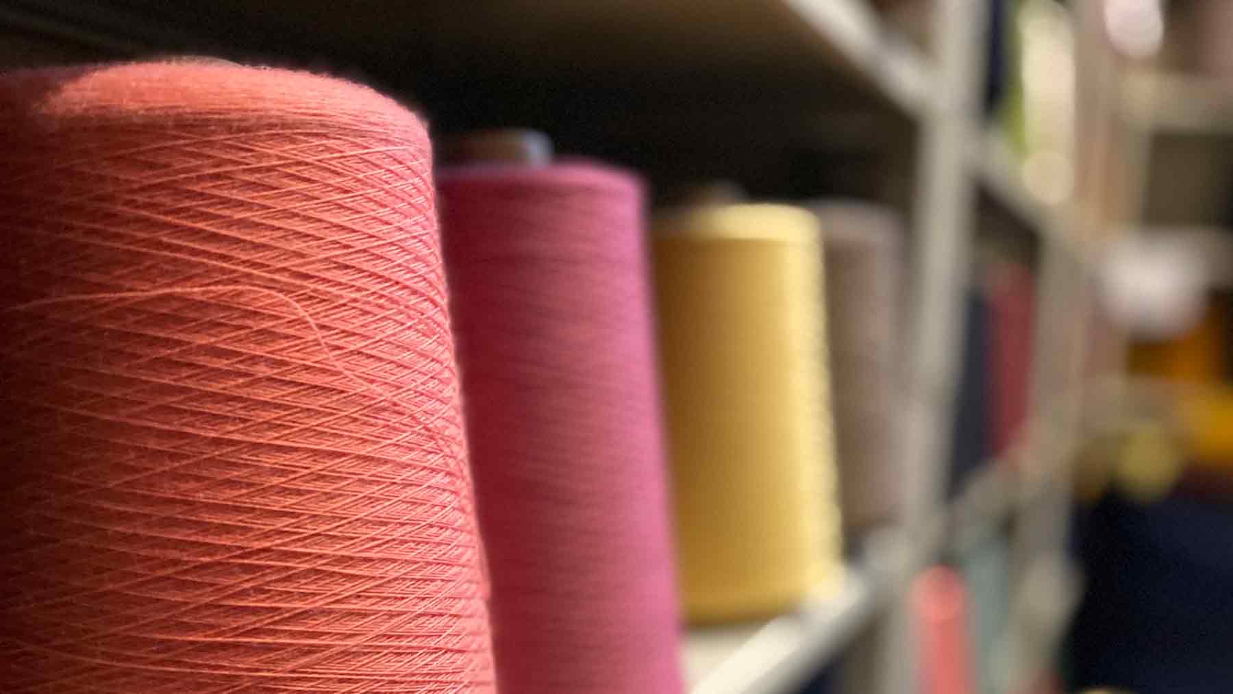 Deadstock yarn on spools at a mill