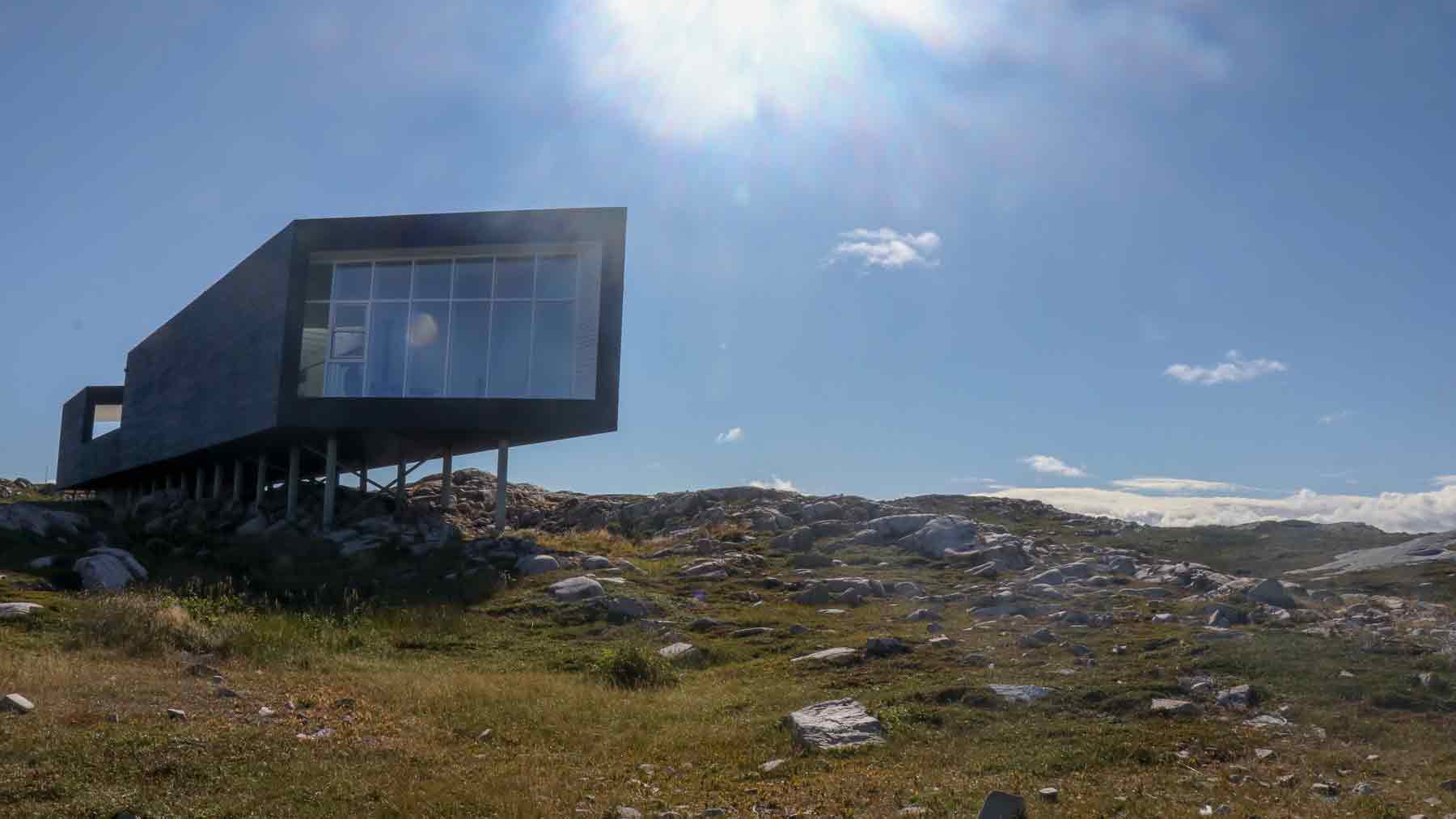 Long artists studio silhouetted against the blue morning sky on Fogo Island