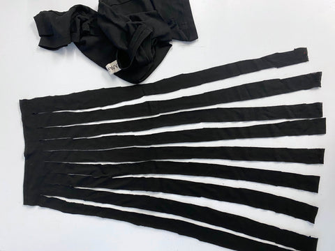 The body of the t-shirt cut into strips that has been separated from the section above the armholes