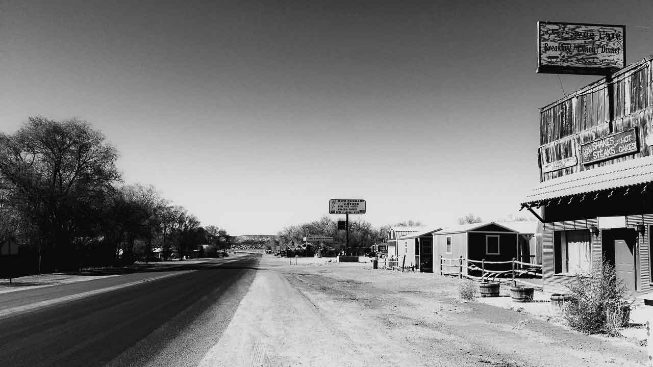 Black and white view down the empty road outside the Dia Art Foundation office in Quemado New Mexico