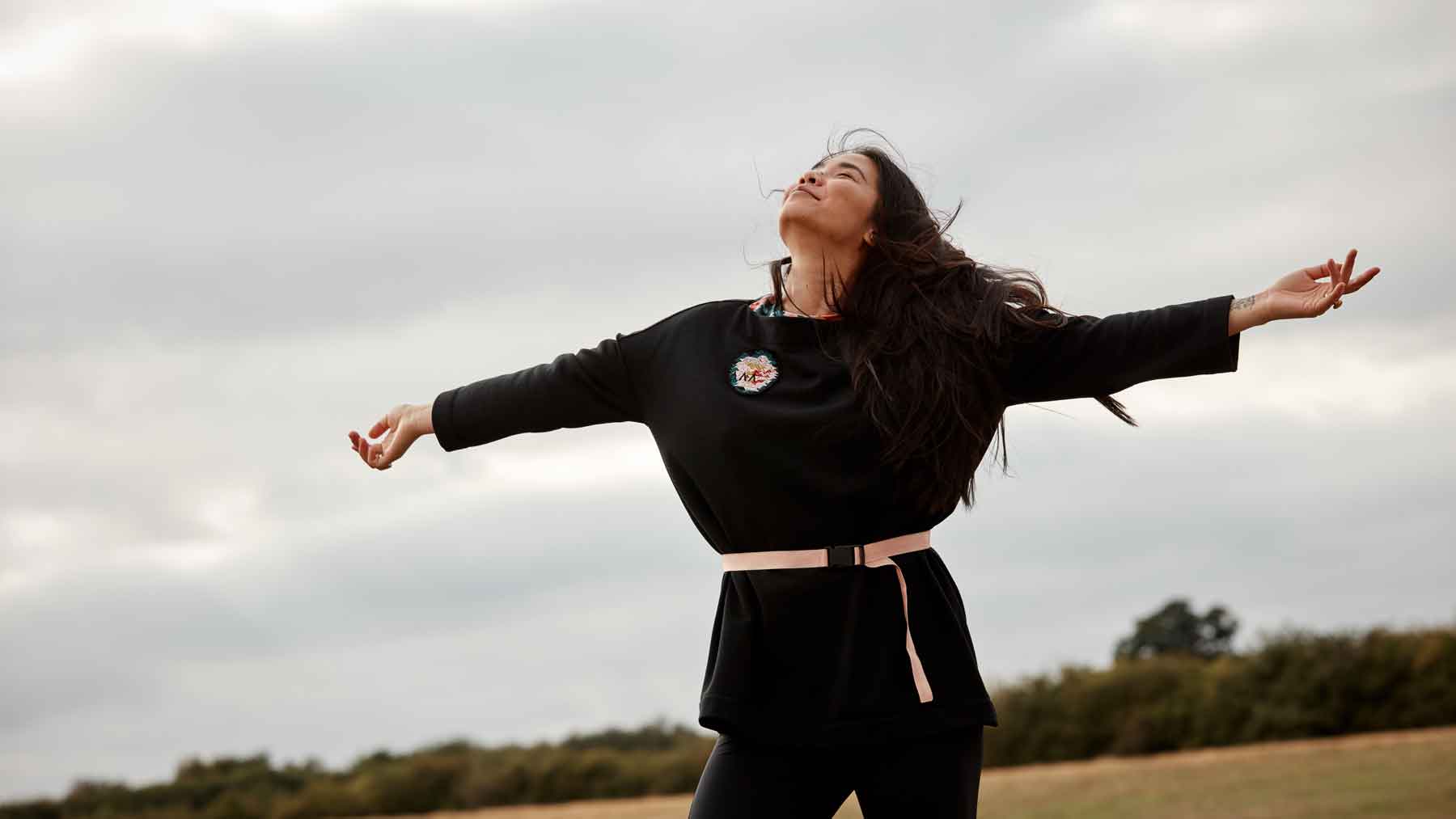 Woman with arms wide open wearing the Asmuss Oversize Boat Neck Sweat made from our Wool Fleece fabric