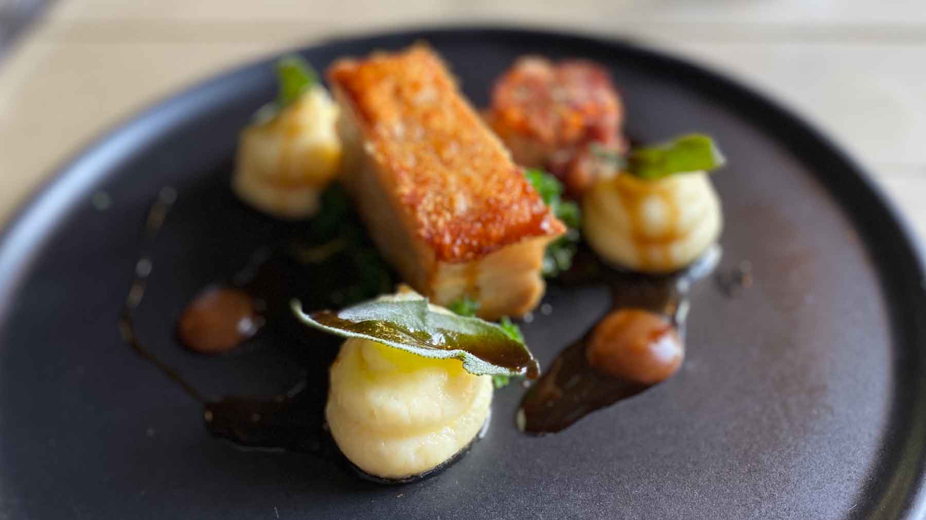 Beautifully prepared and presented pork belly dish at The George Alstonefield, Peak District