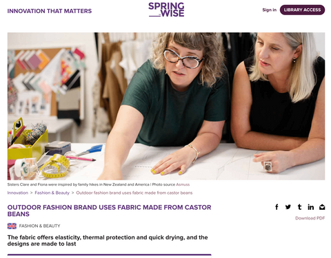 Screenshot of the Springwise Innovation article on Asmuss Clothing showing founders Clare and Fiona at the pattern cutting table in their studio with the headline Outdoor Fashion Brand Uses Fabric Made from Caster Beans