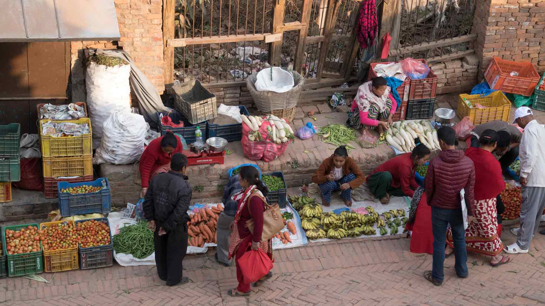 Group discussing the vegetables for sale in the square in Bhaktapur Nepal