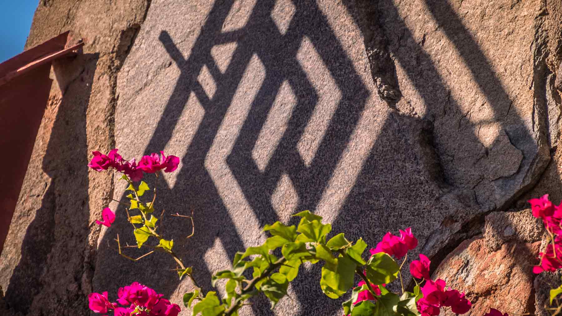 Shadow of the Taliesin West symbol on a wall