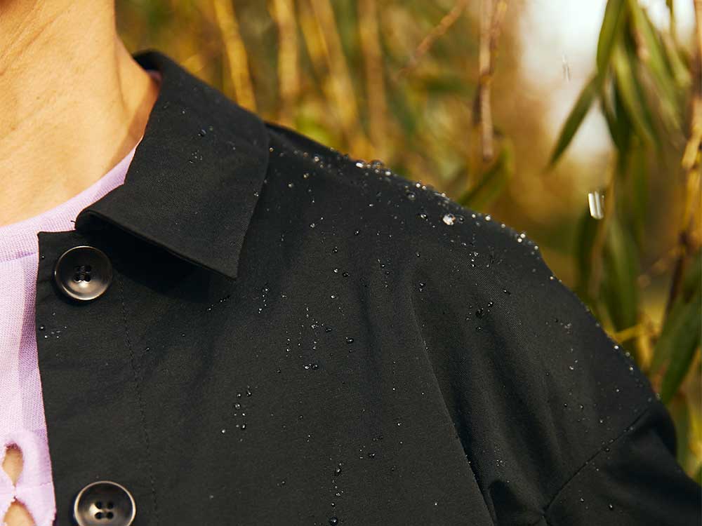 Close up of jacket should showing water beading on water resistant bio castor bean fabric