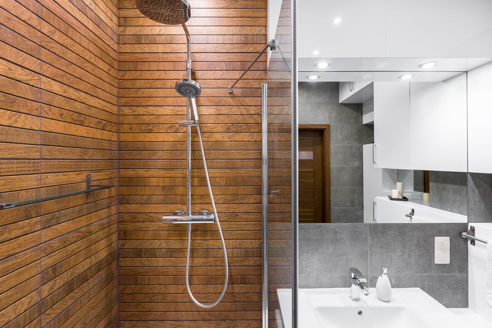 Modern bathroom interior with wooden shower, big mirror and sink