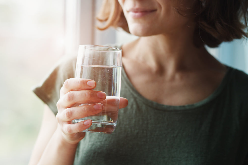 Woman holding glass of water