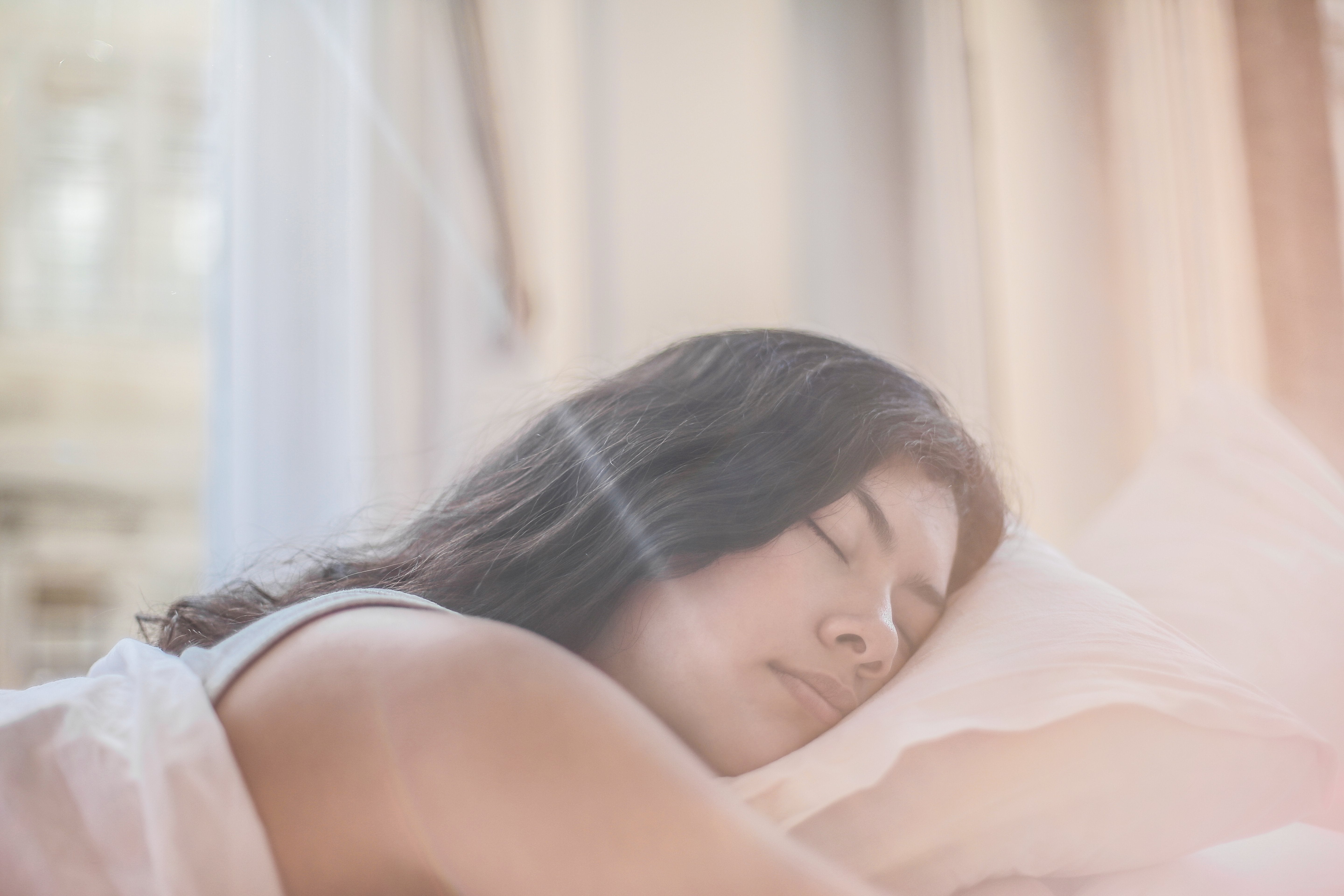 Woman sleeping in comforatble bed