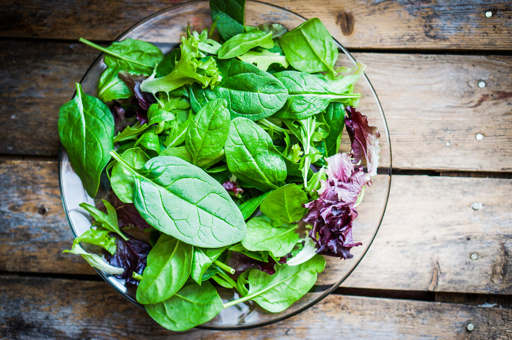 Fresh green salad with spinach, arugula, romaine and lettuce