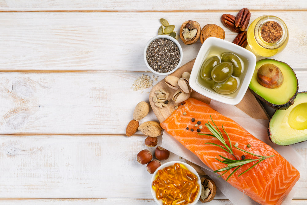 Selection of healthy unsaturated fats, omega 3 - fish, avocado, olives, nuts and seeds