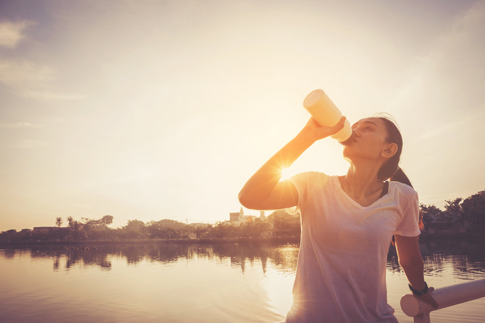 Healthy woman doing exercises and warm up before running and jogging on bridge at morning 