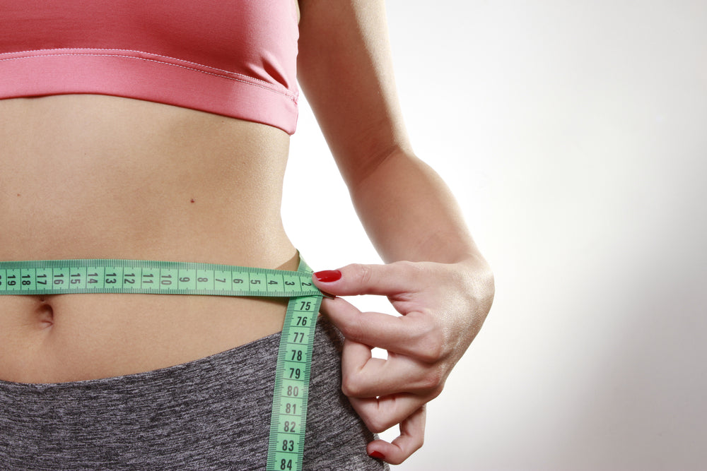 hands tape measuring the abdomen