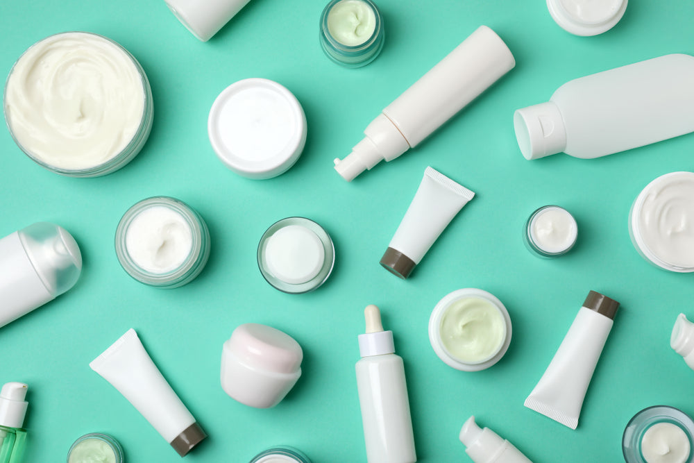 Flat lay composition with cosmetic products on color background