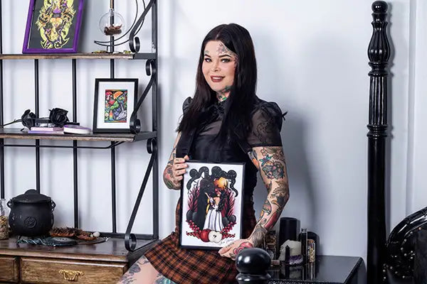 Tattoo Artist Jessie Voorhees Holding her flash tattoo art