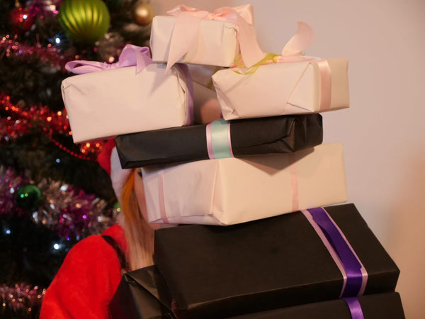 Image of Brydie Claus holding several gifts.