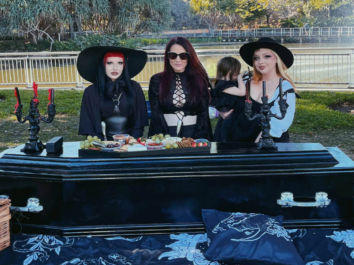 Brydie Brakels, Mel Cramond & Hatsie Brakels of Tragic Beautiful with their coffin picnic setup