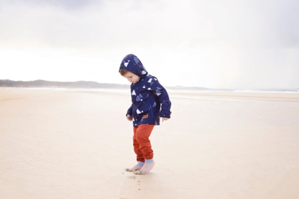 Wild Island Apparel - BTS - navy blue rain jacket at the beach