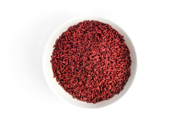 Red yeast rice on a small white plate—one of the best supplements for heart health