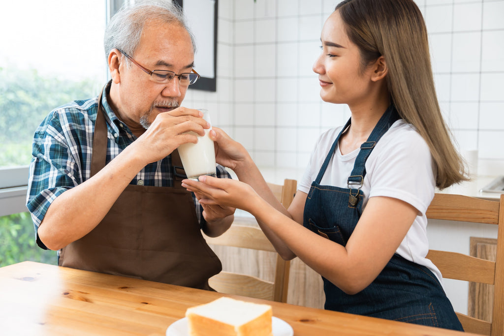 Elderly man drinking liquid collagen for hair growth