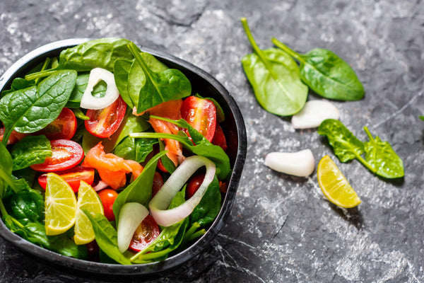 Fresh green salad with spinach and tomatoes recommended for patients recovering from open heart surgery