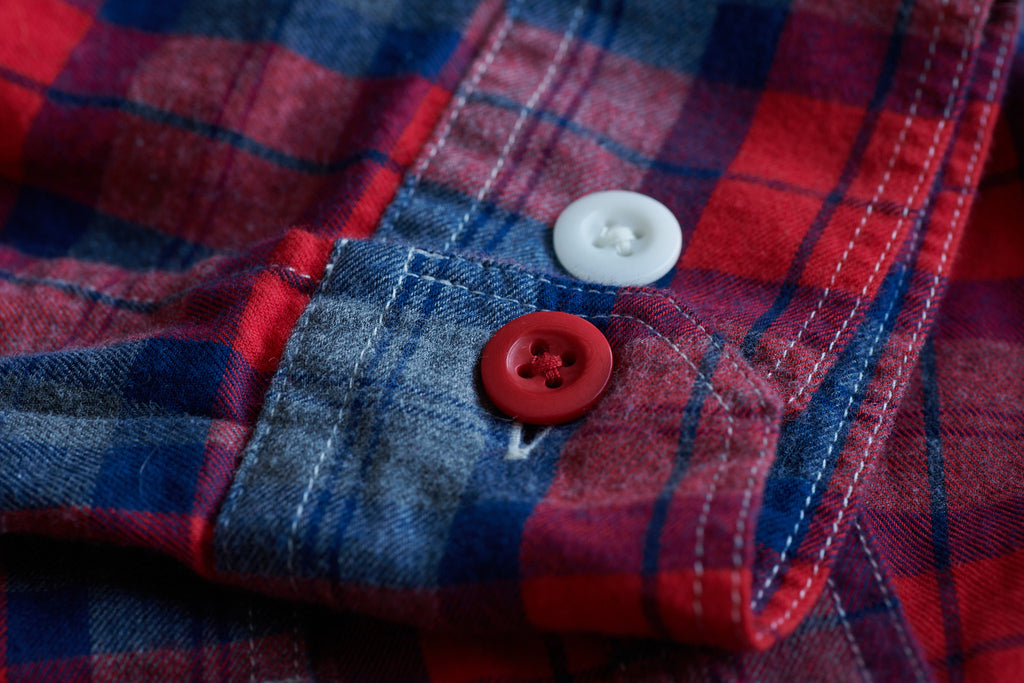 FRAHM LIGHTWEIGHT TARTAN WORKSHIRT CUFF WITH BRITISH COURTNEY'S COROZO BUTTONS. ONE BUTTON ON THIS SHIRT IS ALWAYS RED ON THE LEFT CUFF