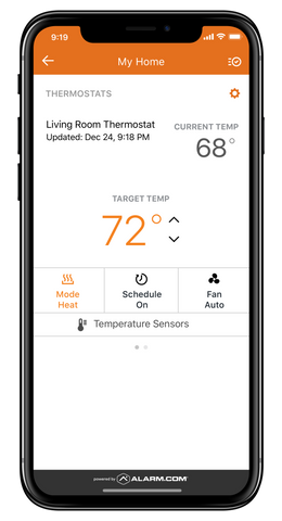 The alarm.com temperature control app displayed on an iphone X screen. The screen shows the target temperature for the room, along with the actual temperature. There are also other controls on screen like fan control and temperature scheduling.