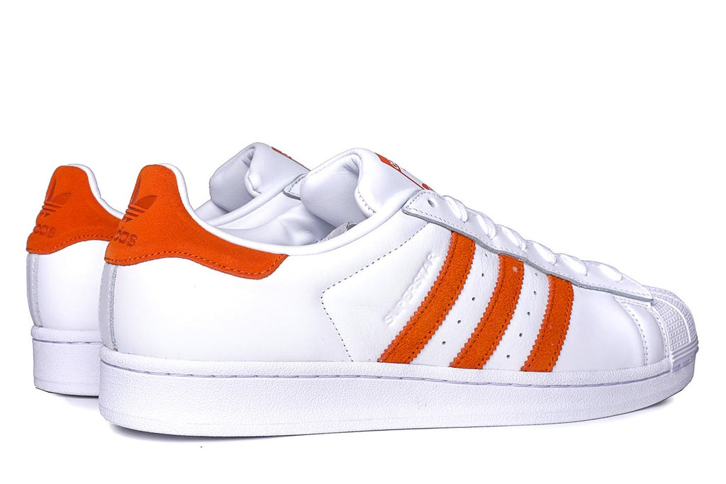 orange and white adidas shoes
