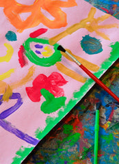 Close up of a child's painting done in bright paint colors.