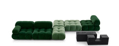 Green modern sofa in various pieces and colors that is modular and can be fit together to make different shapes.