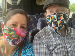 Image of me and my husband wearing masks on the charter bus.