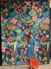 Me standing in front of a large rug designed by Rifle Paper Co.