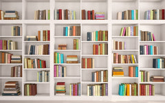 Wall of white bookcases filled with multi-color books