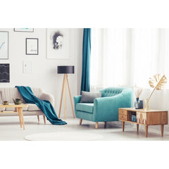 Living room with half a sofa showing, main part of photo is a teal chair with a table next to it.