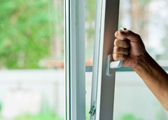 Close up of hand opening a window