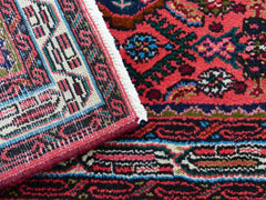 Oriental rug with bold colors such as reds and blues