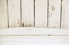 close up of white wood boards going vertically into horizontal wood boards