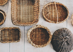 Multiple size and colored baskets hanging on a wall