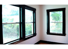 Corner of a room with 3 windows painted with black trim paint