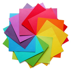 Square pieces of paper all different colors arranged in a circle