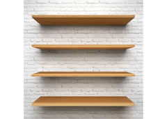 Light wood floating shelves on a white brick wall