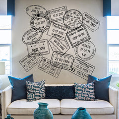 Image of a sofa with a wall behind it full of large passport wall decals.